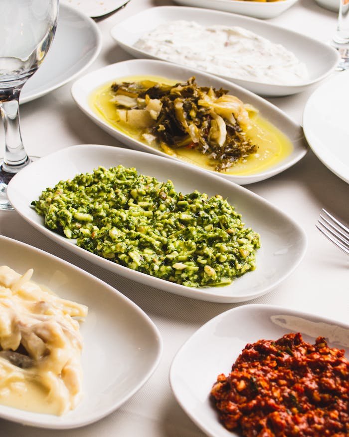 A vibrant assortment of Mediterranean meze dishes arranged on a table, showcasing diverse flavors and colors.