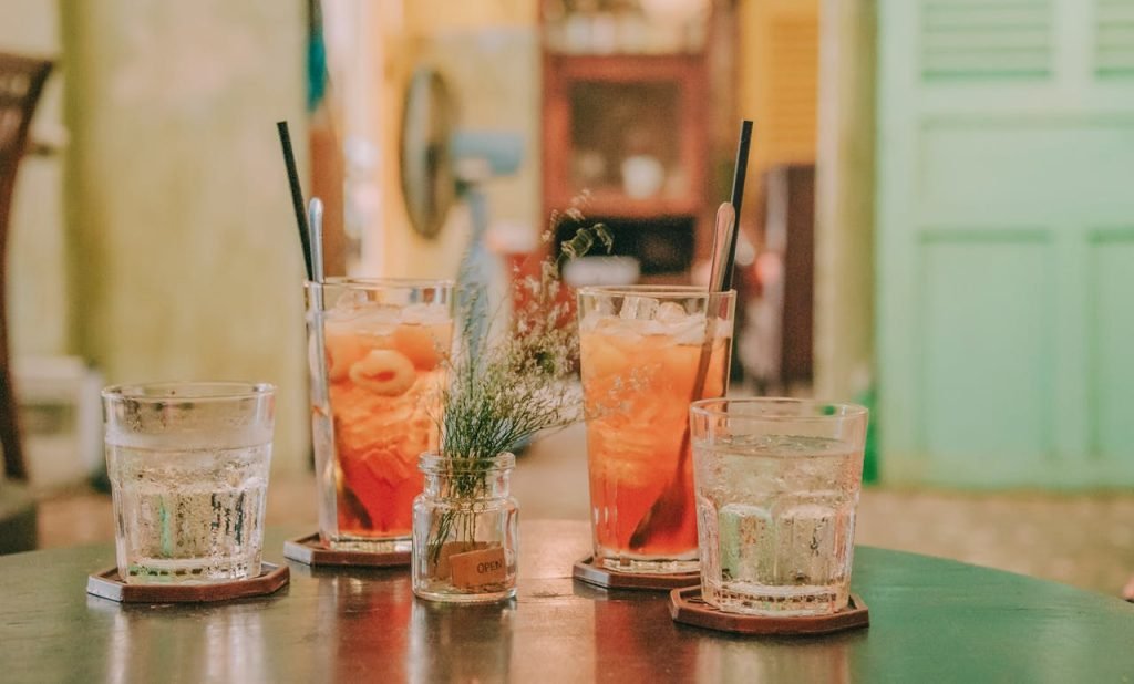 Close-up of refreshing lychee cocktails served with ice, perfect for indoor summer gatherings.
